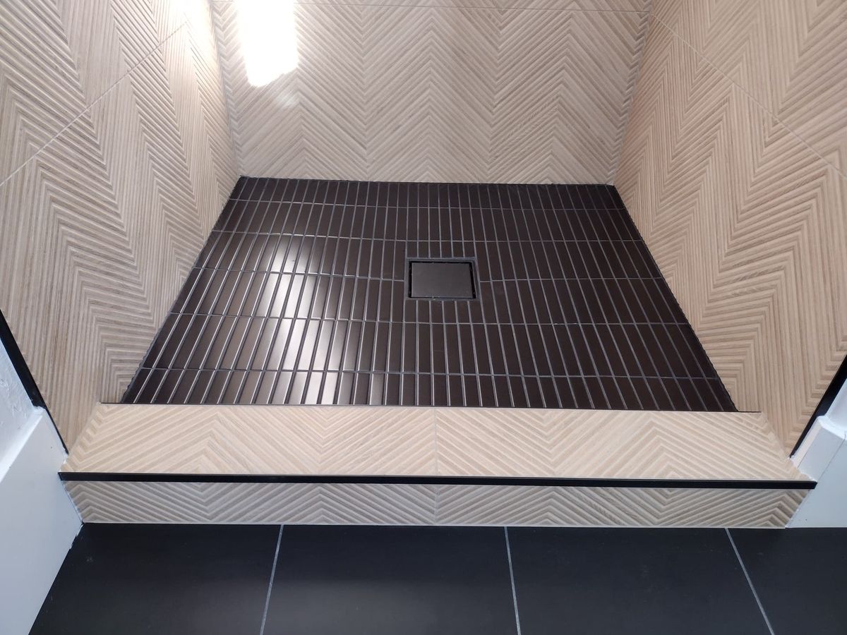 Walk-in shower with herringbone tile